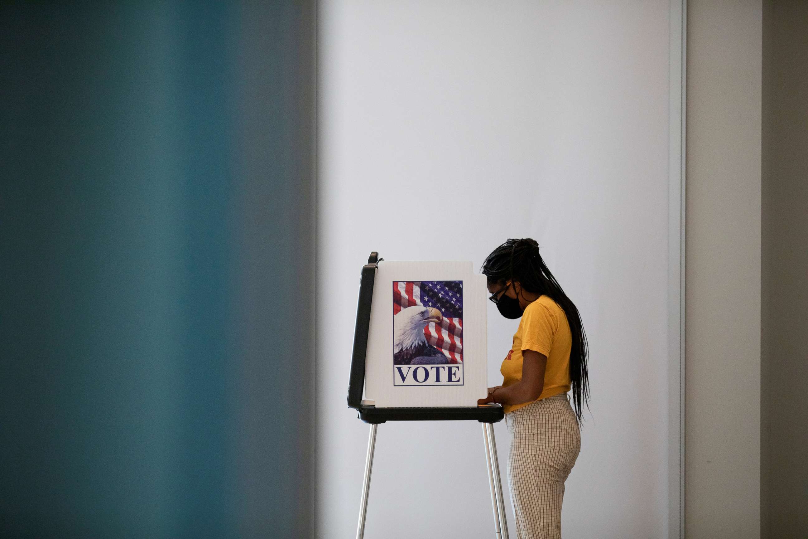 PHOTO: A woman casts her ballot for the upcoming presidential elections as early voting begins in Ann Arbor, Mich., Sept. 24, 2020.  