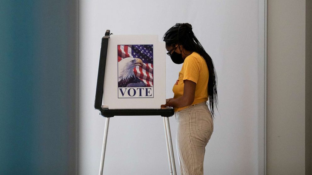 PHOTO: A woman casts her ballot for the upcoming presidential elections as early voting begins in Ann Arbor, Mich., Sept. 24, 2020.  