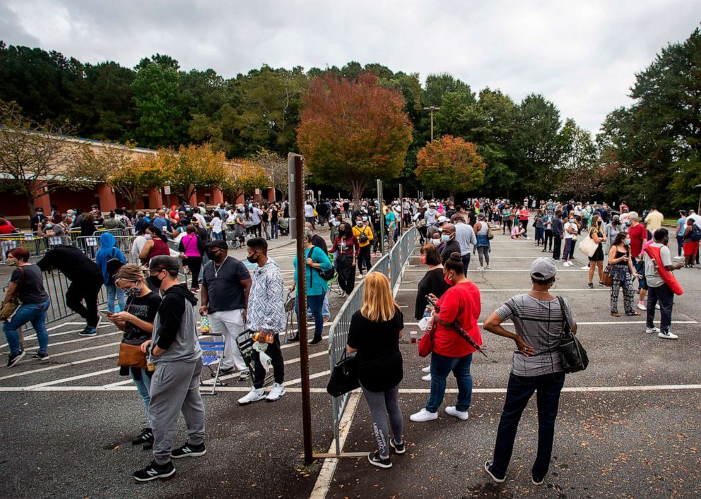 PHOTO: Hundreds of people wait in line for early voting in Marietta, Ga., Oct. 12, 2020. 