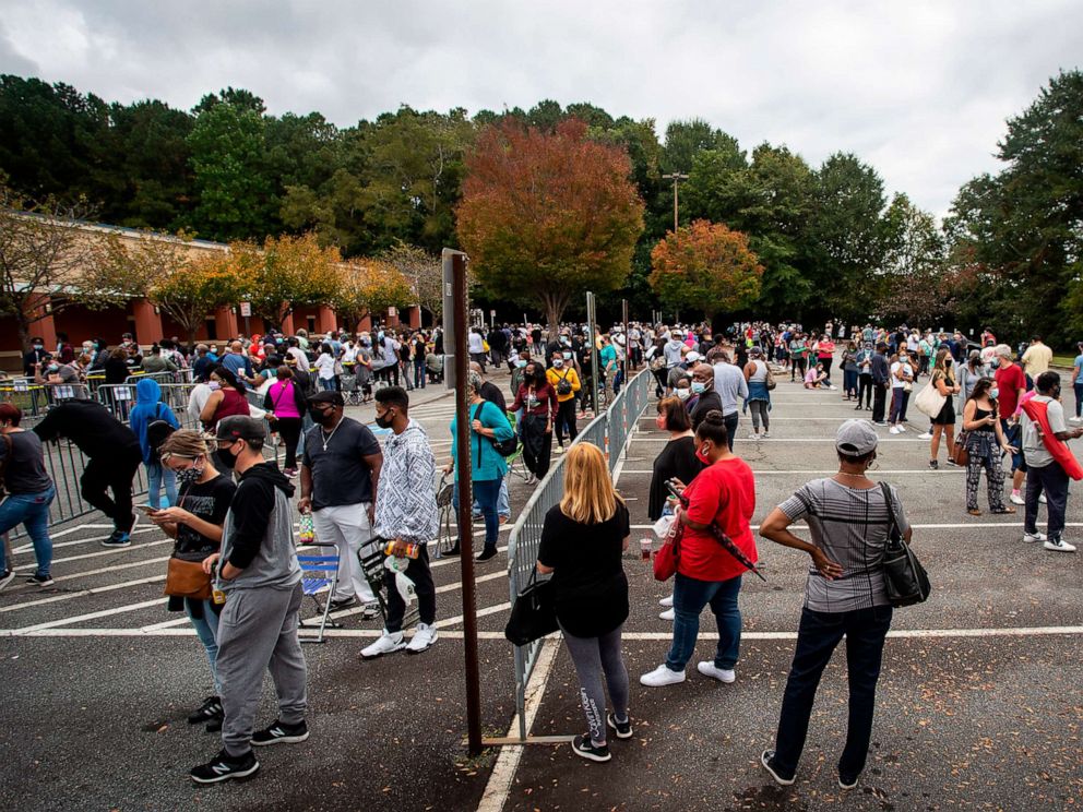 PHOTO: Hundreds of people wait in line for early voting in Marietta, Ga., Oct. 12, 2020. 