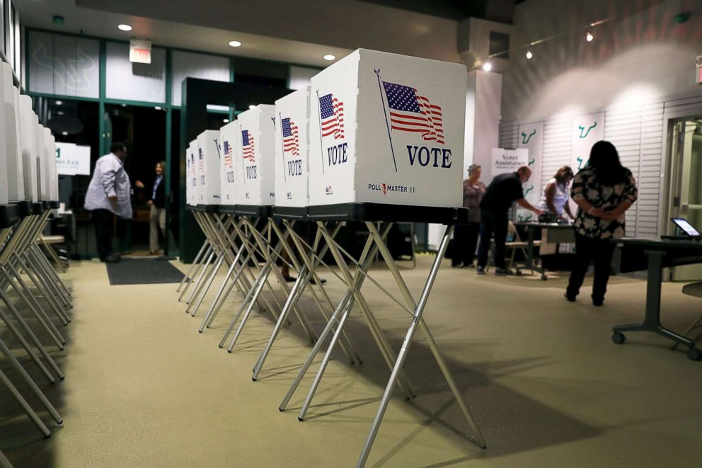 PHOTO: Voting booths are setup at the Yuengling center on the campus of University of South Florida as workers prepare to open the doors to early voters, Oct. 22, 2018, in Tampa, Fla.