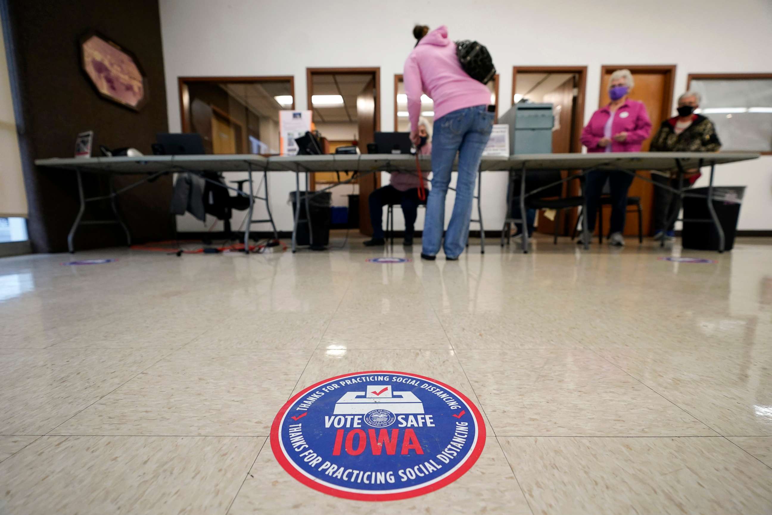PHOTO: A local resident gets her ballot during early voting, Oct. 20, 2020, in Adel, Iowa.