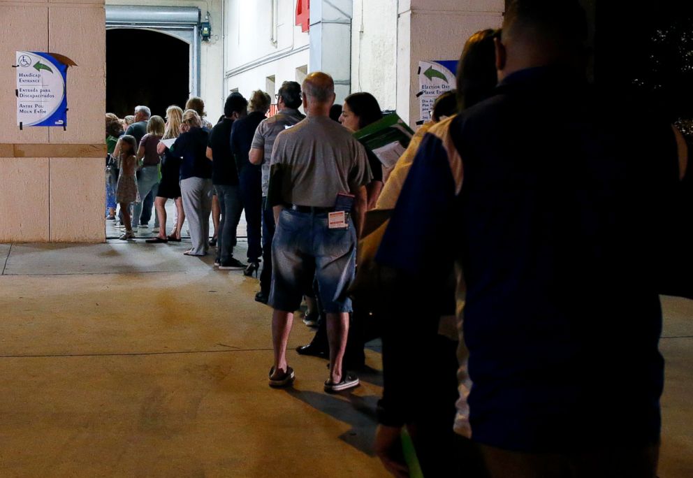 PHOTO: People wait in line to vote at a polling station in Miami, late Nov. 6, 2018. 