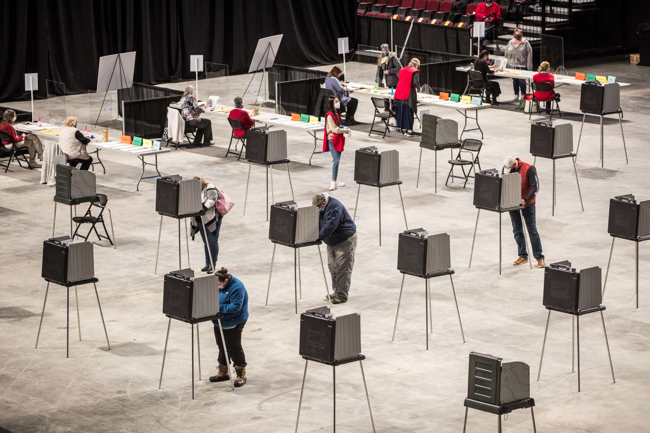 PHOTO: Voters fill out and cast their ballots at the Cross Insurance Center polling location where the entire city votes on Nov. 3, 2020 in Bangor, Maine.