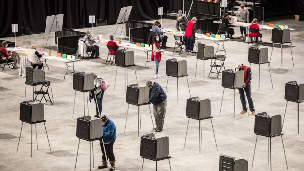 PHOTO: Voters fill out and cast their ballots at the Cross Insurance Center polling location where the entire city votes on Nov. 3, 2020 in Bangor, Maine.