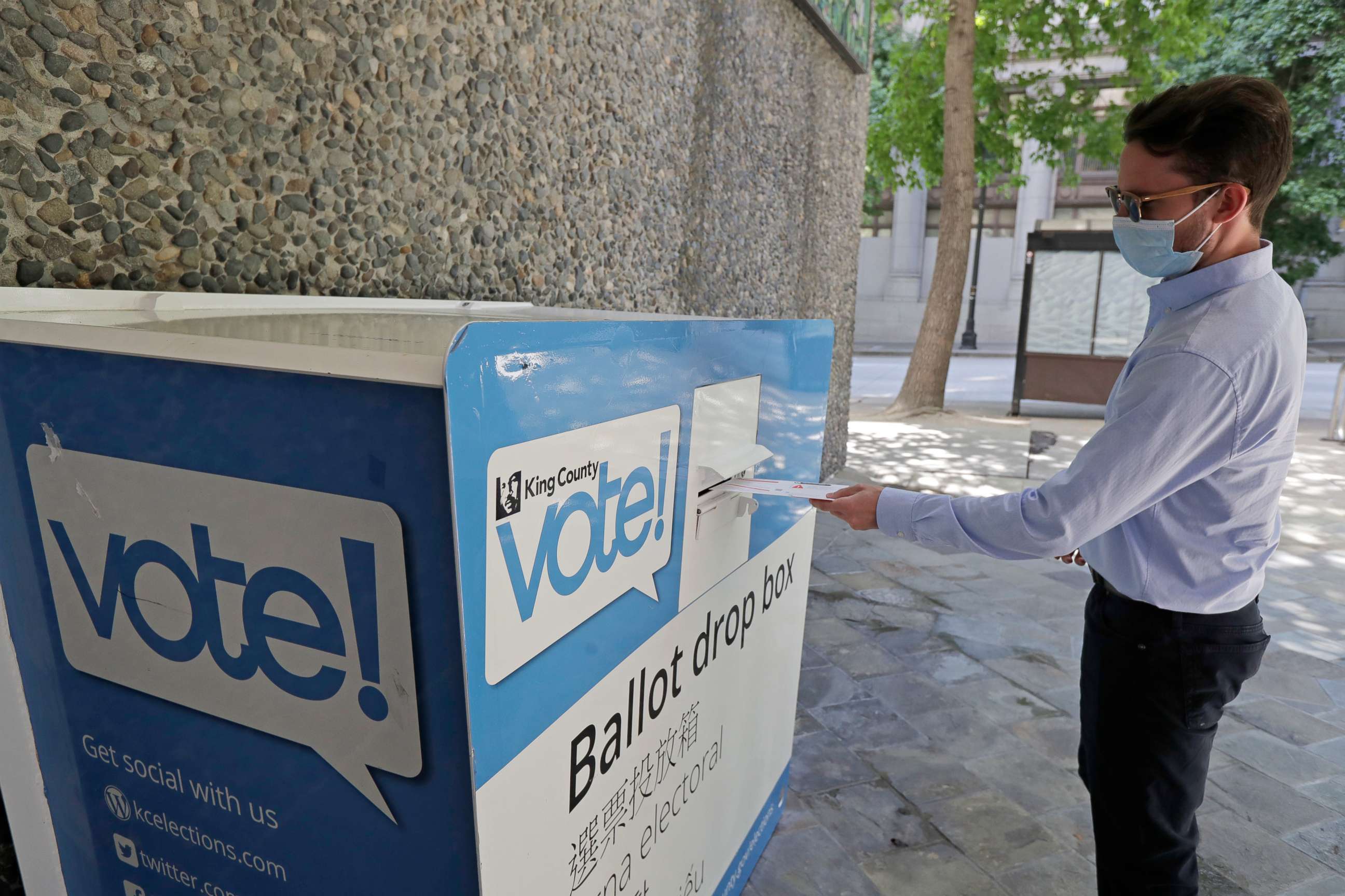 PHOTO: A person drops off a ballot for Washington state's primary election Tuesday, Aug. 4, 2020, at a collection box at the King County Administration Building in Seattle. 