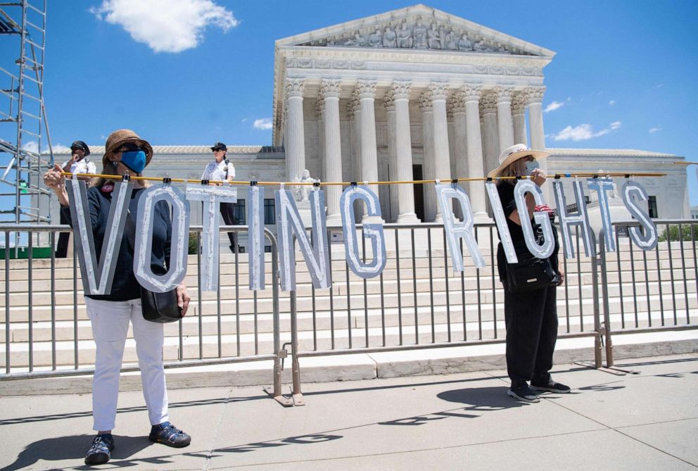 PHOTO: Demonstrators call for senators to support the elimination of the Senate filibuster in order to pass voting rights legislation and economic relief bills, as they protest during the "Moral March" outside the Supreme Court, June 23, 2021.