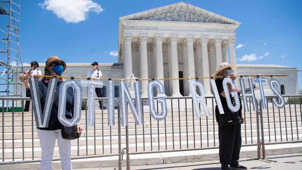 Demonstrators call for senators to support the elimination of the Senate filibuster in order to pass voting rights legislation and economic relief bills, as they protest during the "Moral March" outside the Supreme Court in Washington on June 23, 2021.