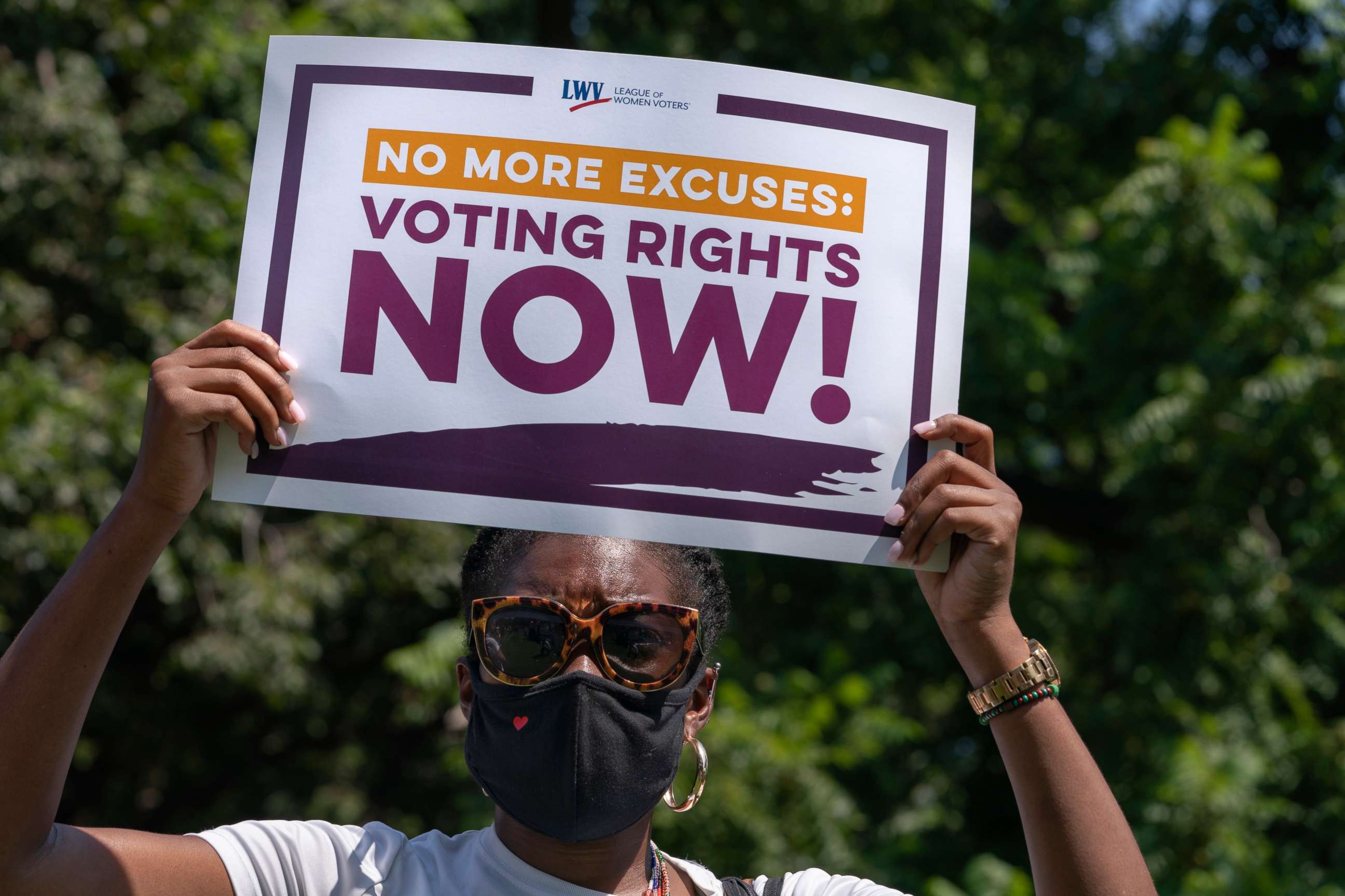 PHOTO: LaQuita Howard of Washington, with the League of Women Voters, attends a rally for voting rights, Aug. 24, 2021, near the White House in Washington.