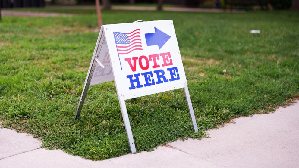 PHOTO: A "Vote here" sign directs people towards a voting site on primary election day in Minneapolis, Aug. 11, 2026. 