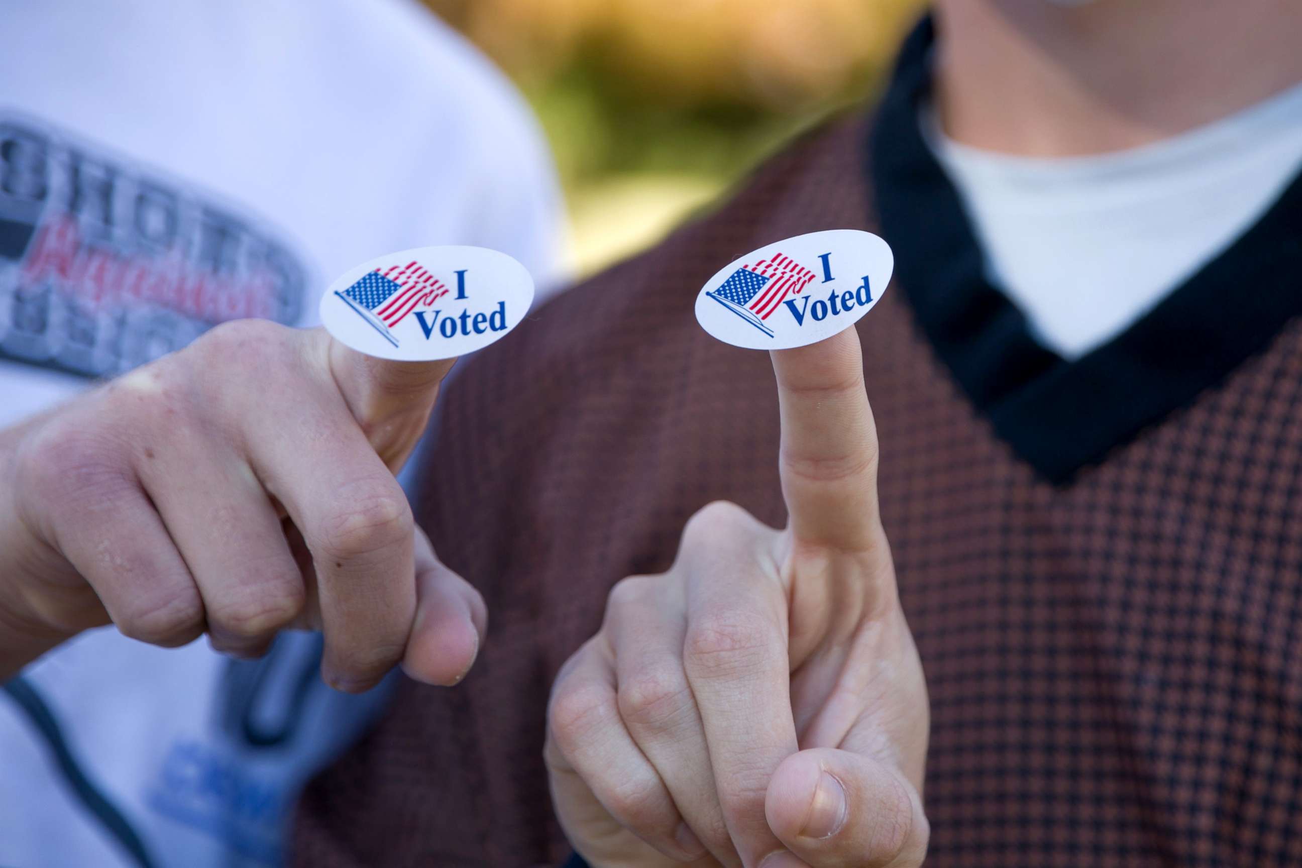 PHOTO: Young voters show the "I Voted" stickers after voting at a polling station in Plano, Texas, Nov. 3, 2020.