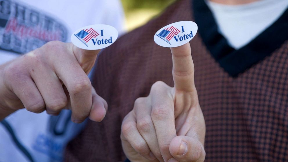 PHOTO: Young voters show the "I Voted" stickers after voting at a polling station in Plano, Texas, Nov. 3, 2020.