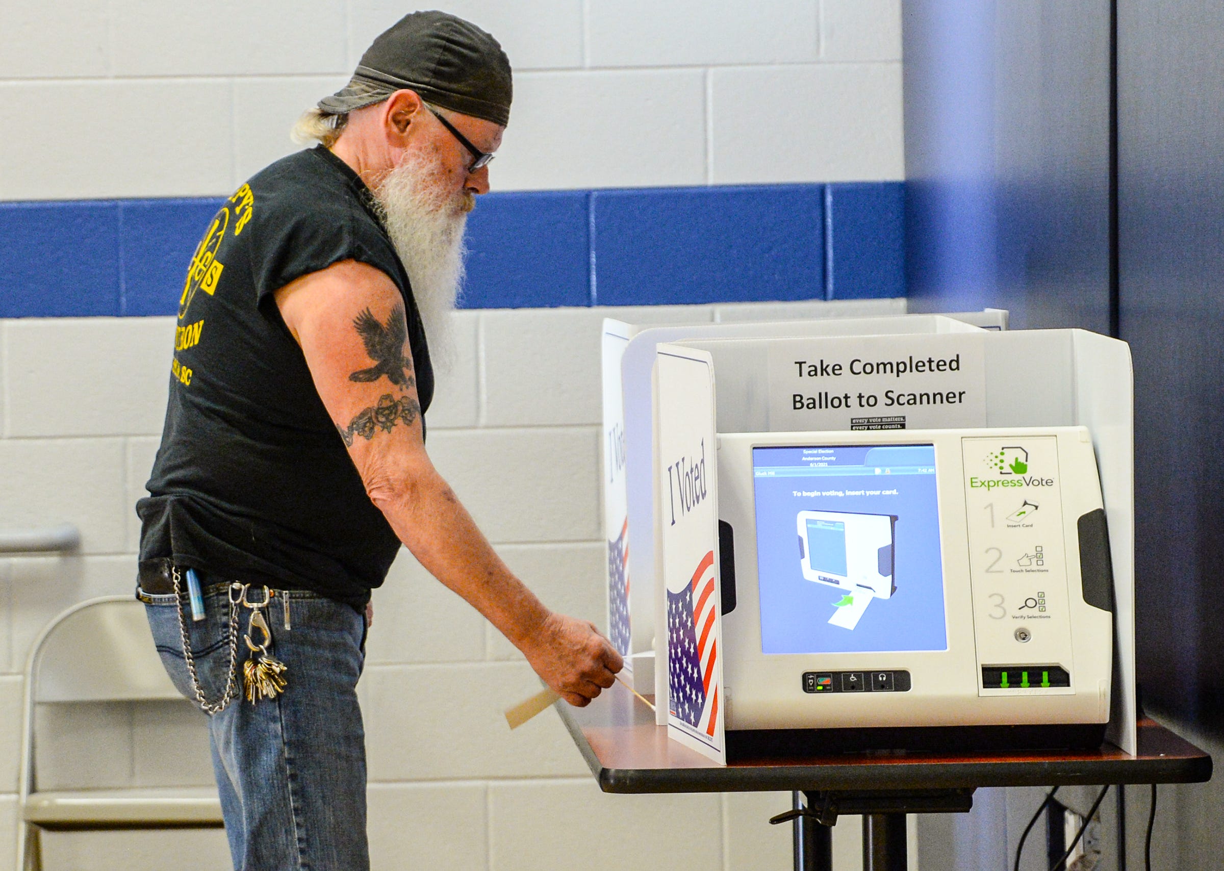 PHOTO: Dave Laire votes at the Gluck Mill precinct in the Homeland Park Elementary School gymnasium during voting for Anderson County Council  special election to fill the District 2 seat in Anderson, S.C., June 1, 2021.

