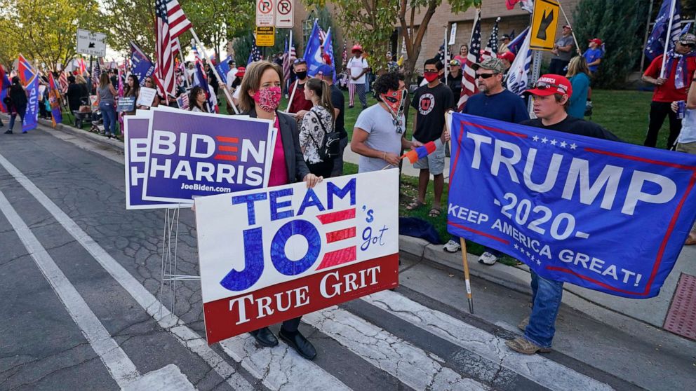 PHOTO: People holding signs in support gather near the site of the vice presidential debate between Vice President Mike Pence and Sen. Kamala Harris, at the University of Utah Oct. 7, 2020, in Salt Lake City.