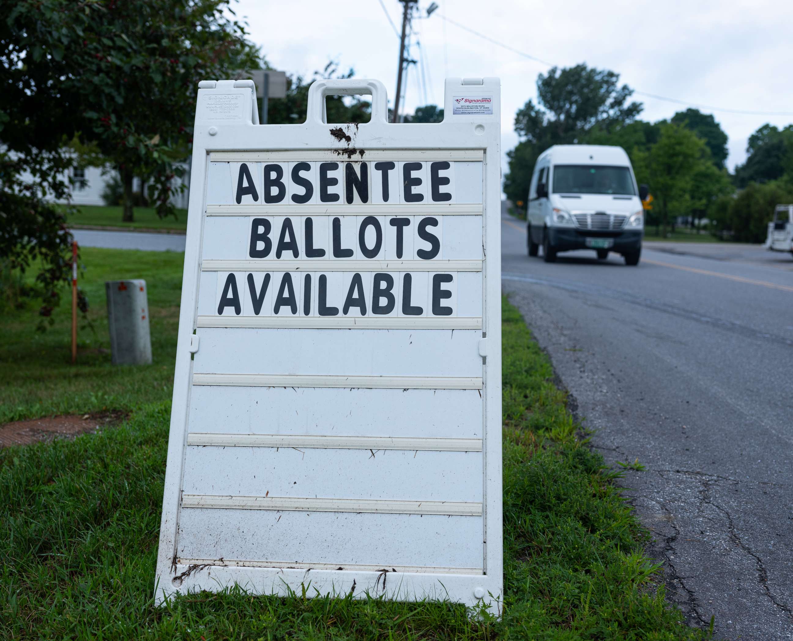 PHOTO: A street sign announces availability of absentee ballots for the Vermont primary voting outside of the town hall on Aug. 10, 2020, in Charlotte, Vt.