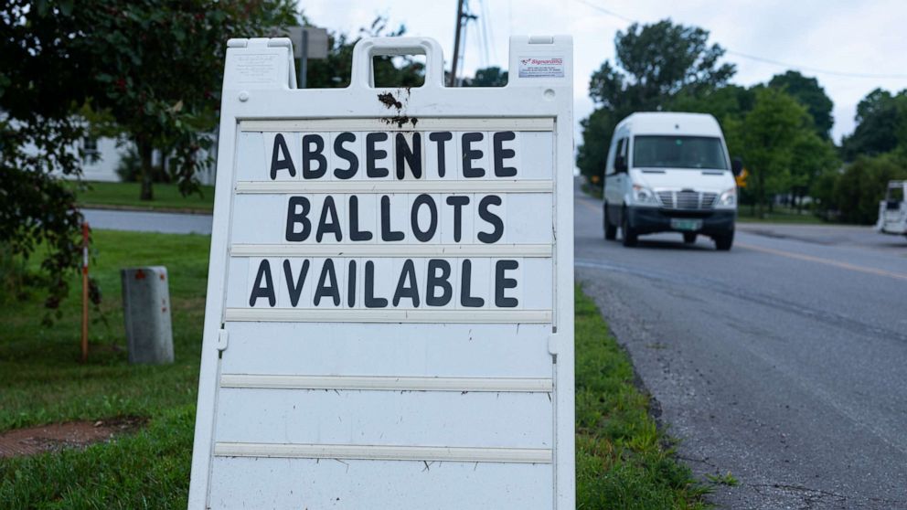 PHOTO: A street sign announces availability of absentee ballots for the Vermont primary voting outside of the town hall on Aug. 10, 2020, in Charlotte, Vt.