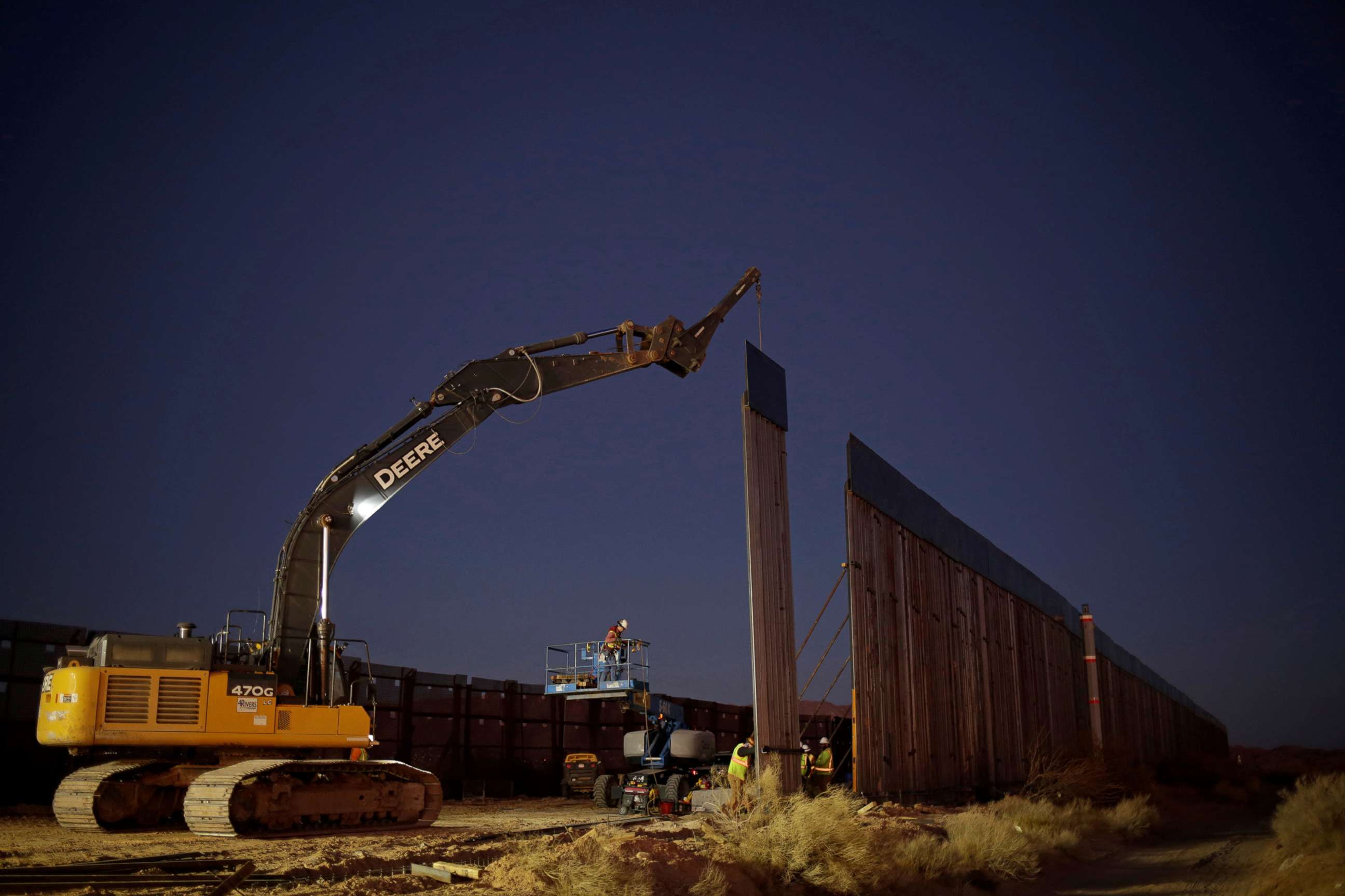 PHOTO: Members of a construction crew using heavy machinery work on a new section of the bollard-type border wall in Sunland Park, N.M., as seen from the Mexican side of the border in Ciudad Juarez, Mexico, Jan. 15, 2021.