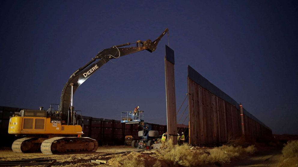 PHOTO: Members of a construction crew using heavy machinery work on a new section of the bollard-type border wall in Sunland Park, N.M., as seen from the Mexican side of the border in Ciudad Juarez, Mexico, Jan. 15, 2021.