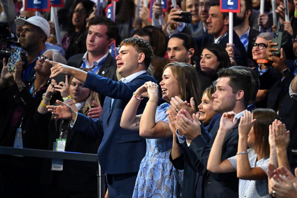 PHOTO: Minnesota Governor and 2024 Democratic vice presidential candidate Tim Walz's son Gus (L) and daughter Hope (2nd L) react as he speaks on Day 3 of the Democratic National Convention at the United Center in Chicago, Aug. 21, 2024.