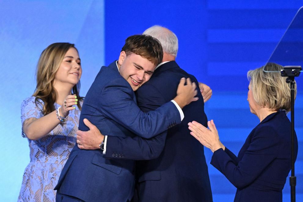 PHOTO: After concluding his remarks, Minnesota Governor and Democratic vice presidential candidate Tim Walz is embraced by his son Gus (2L) as daughter Hope (L) and wife Gwen Walz (R) at the United Center in Chicago, Aiug. 21, 2024.