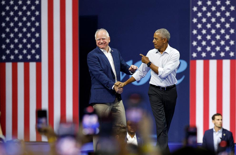 PHOTO: Former President Barack Obama greets Minnesota Governor and Democratic vice presidential candidate Tim Walz during a campaign rally, in Madison, Wisconsin, on Oct. 22, 2024. 