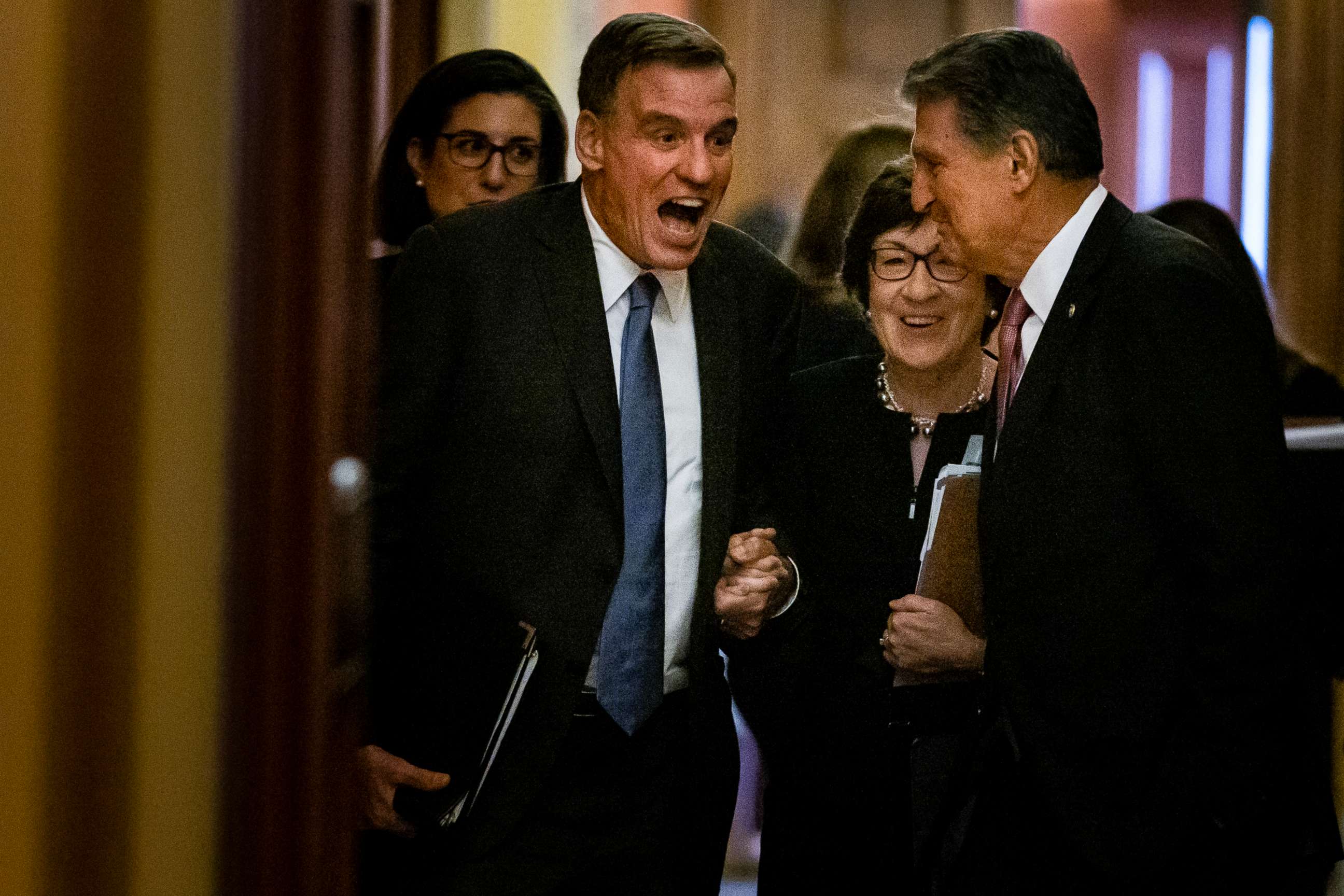 PHOTO: Sens. Mark Warner, D-Va., Susan Collins, R-Maine, and Joe Manchin, D-W.Va., talk as they leave a meeting between a bipartisan group of senators and White House officials where they were negotiating an infrastructure plan on June 23, 2021.