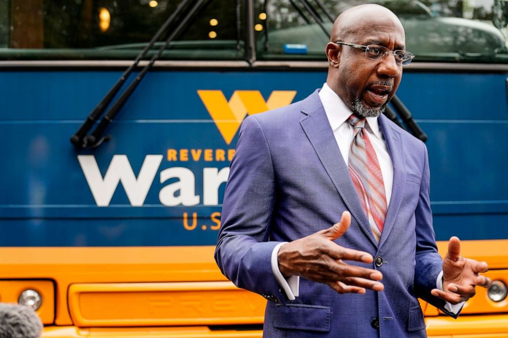 PHOTO: Democratic candidate for Senate Raphael G. Warnock speaks to a crowd during a "Get Out the Early Vote" event at the SluttyVegan ATL restaurant on Tuesday, Oct. 27, 2020, in Jonesboro, Ga.