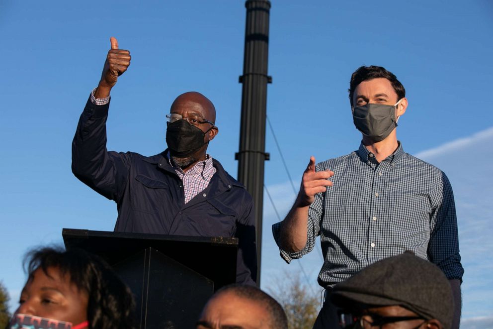 PHOTO: Democratic U.S. Senate candidates Jon Ossoff (R) and Raphael Warnock (L) of Georgia hold a rally on November 15, 2020 in Marietta, Georgia. 