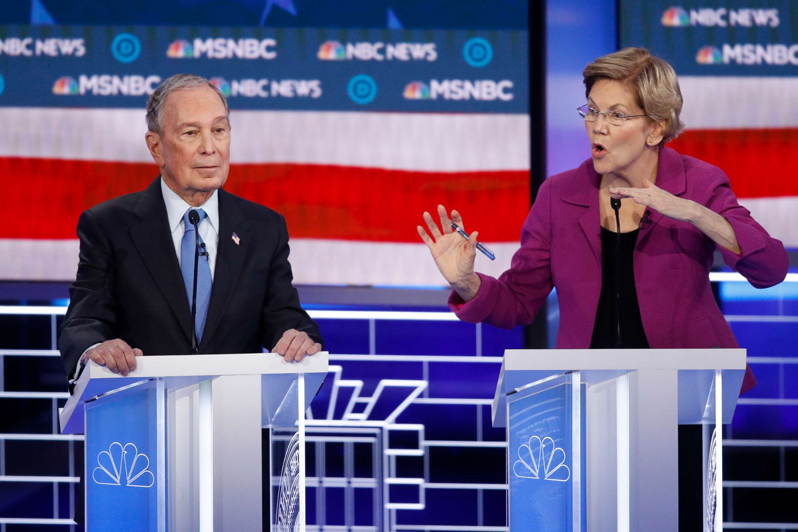 PHOTO: Democratic presidential candidates, former New York City Mayor Mike Bloomberg, left, looks on as Sen. Elizabeth Warren, D-Mass., speak during a Democratic presidential primary debate, Feb. 19, 2020, in Las Vegas, hosted by NBC News and MSNBC.