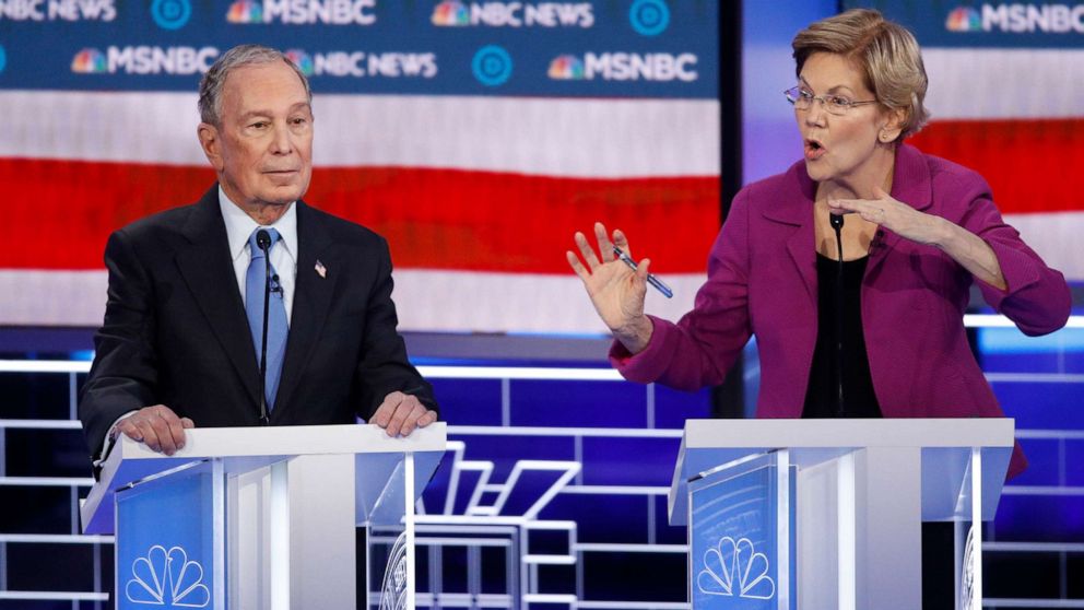 PHOTO: Democratic presidential candidates, former New York City Mayor Mike Bloomberg, left, looks on as Sen. Elizabeth Warren, D-Mass., speak during a Democratic presidential primary debate, Feb. 19, 2020, in Las Vegas, hosted by NBC News and MSNBC.