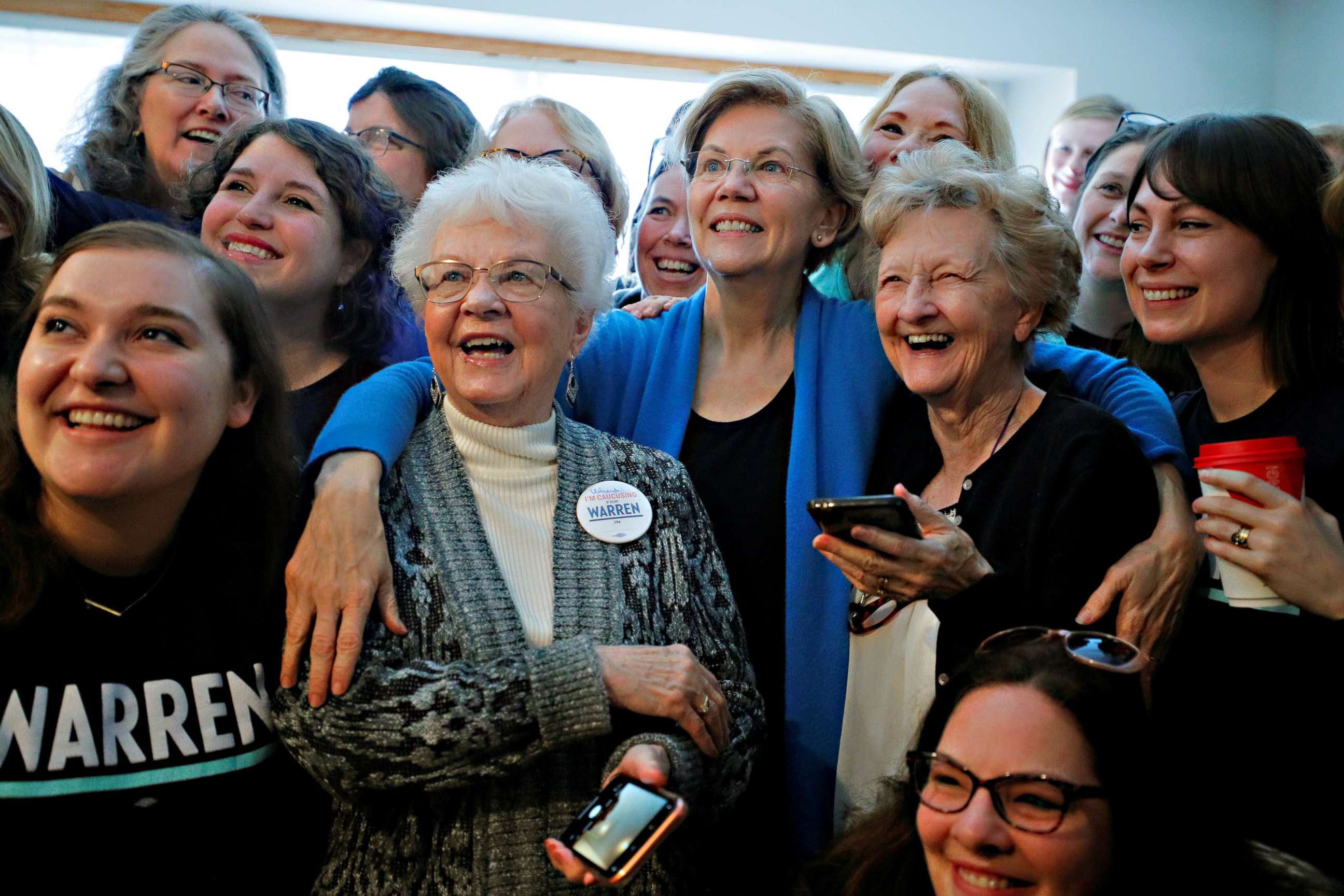PHOTO: Sen. Elizabeth Warren poses for a group photo at a Democratic presidential campaign canvass kickoff at the home of a supporter in Urbandale, Iowa, Feb. 1, 2020.