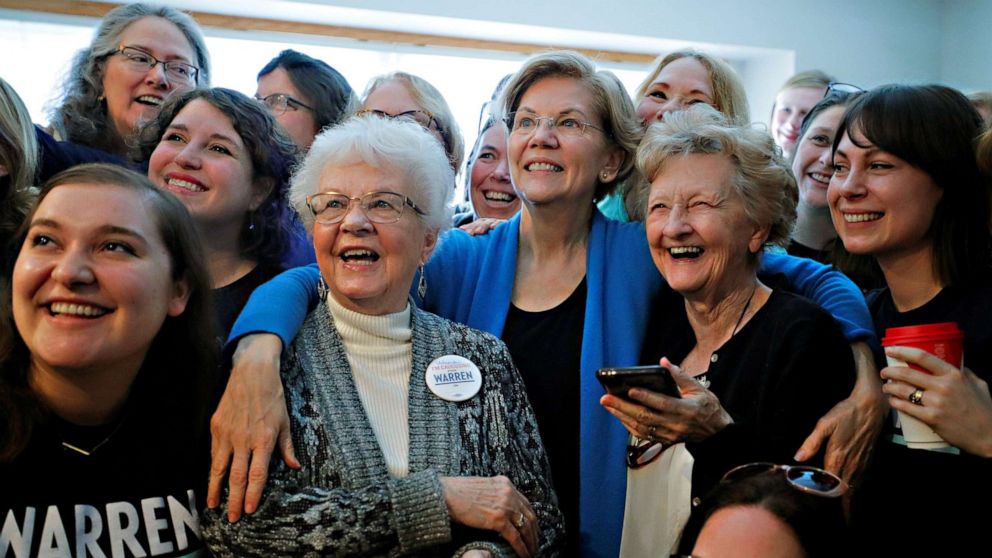 PHOTO: Sen. Elizabeth Warren poses for a group photo at a Democratic presidential campaign canvass kickoff at the home of a supporter in Urbandale, Iowa, Feb. 1, 2020.