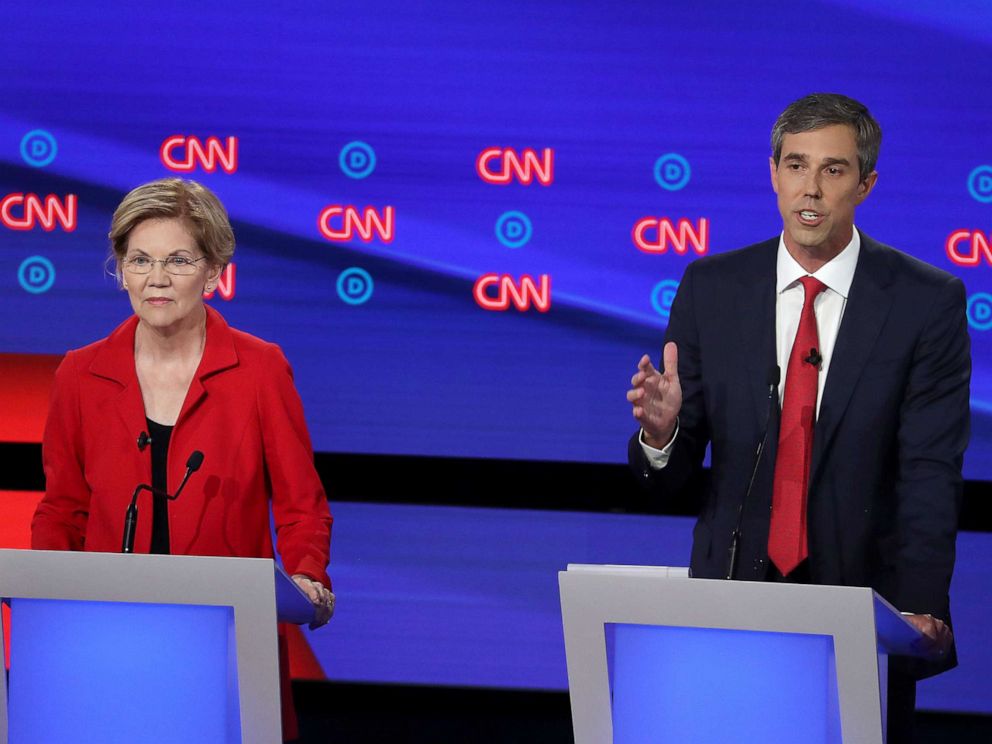 PHOTO: Democratic presidential candidate former Texas congressman Beto ORourke, right, speaks while Sen. Elizabeth Warren listens during the Democratic Presidential Debate at the Fox Theatre July 30, 2019 in Detroit.