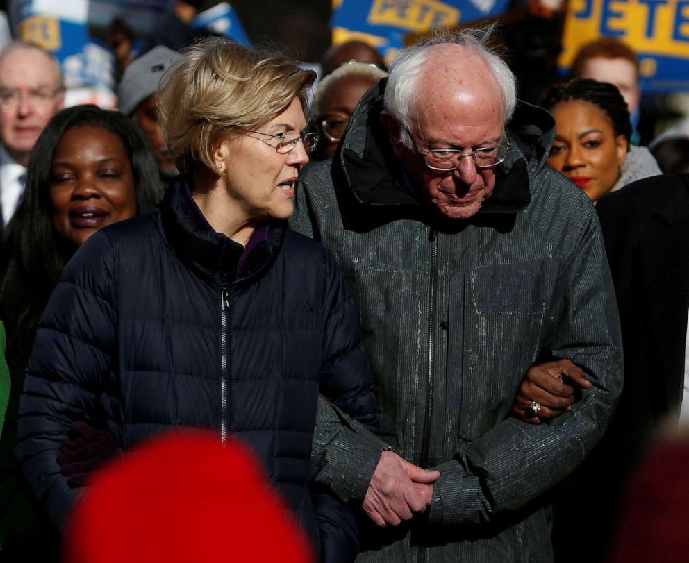 PHOTO: Sen. Elizabeth Warren and Sen. Bernie Sanders, walk arm-in-arm with local African-American leaders during the Martin Luther King Jr. Day Parade in Columbia, S.C., Jan. 20, 2020.
