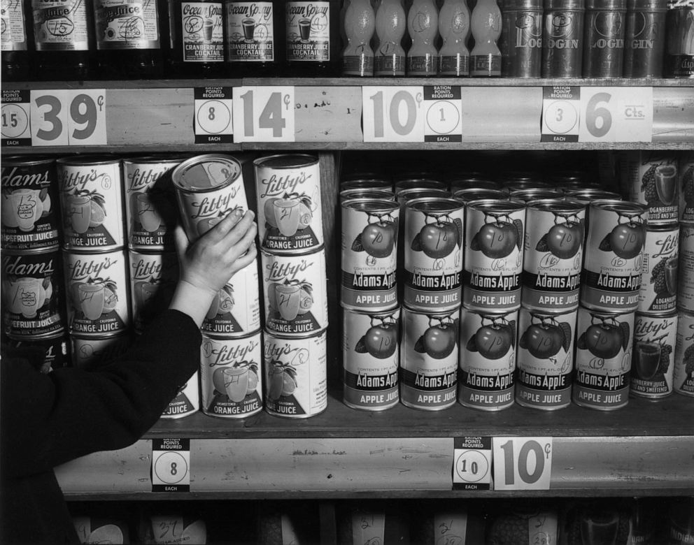 PHOTO: A person reaches for a can of orange juice from a grocery shelf during World War II, February 1943. 
