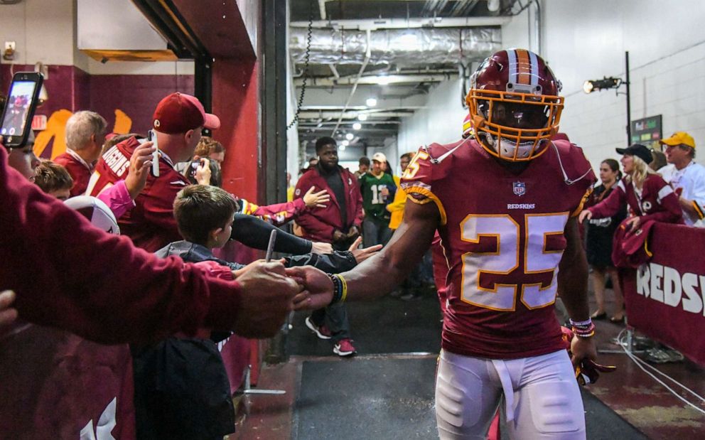 PHOTO: Washington Redskins running back Chris Thompson greets fans as he takes the field for action against the Green Bay Packers at  FedEx Field.