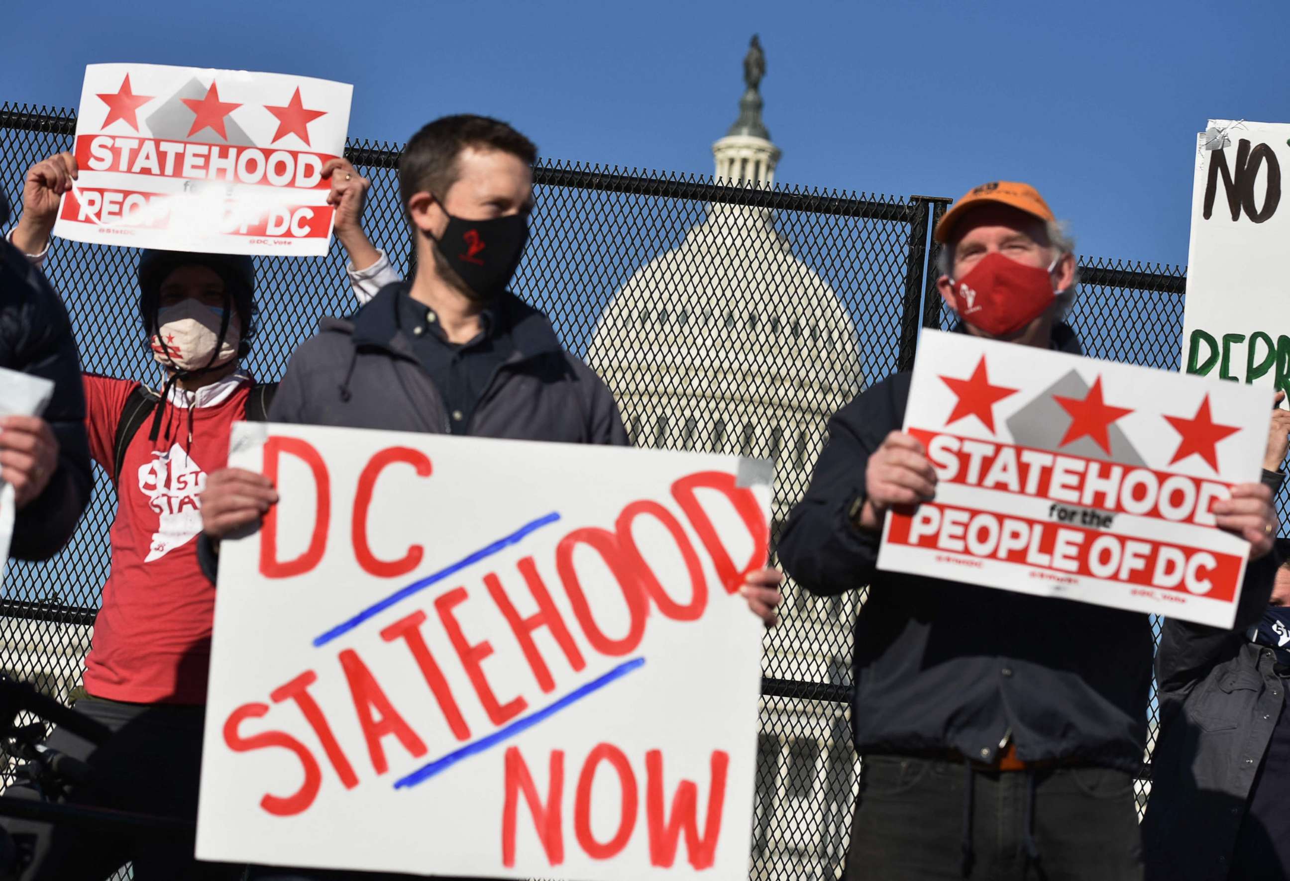 PHOTO:Activists hold signs as they take part in a rally in support of DC statehood near the US Capitol in Washington, March 22, 2021.