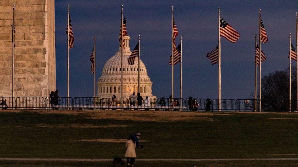 PHOTO: The U.S. Capitol is seen past the Washington Monument as the sun sets on Dec. 26, 2020, in Washington, D.C.