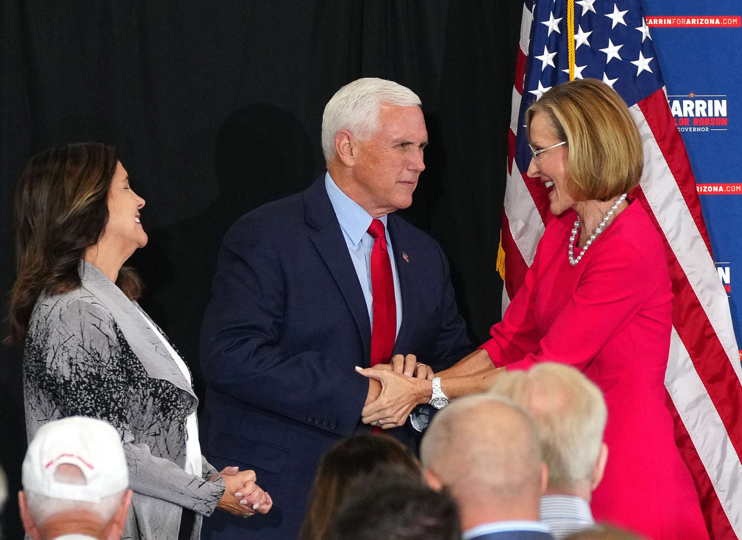 PHOTO: Former Vice President Mike Pence and his wife Karen Pence shake hands with gubernatorial candidate Karrin Taylor Robson during her campaign event in Peoria, Ariz, July 22, 2022.