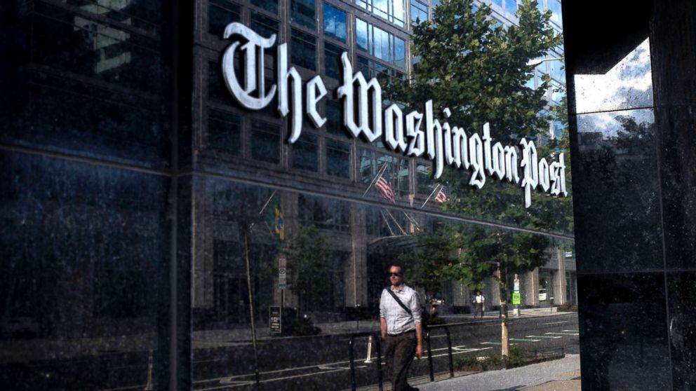 A man walks past The Washington Post, Aug. 5, 2013 in Washington, DC.
