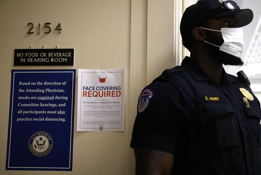 PHOTO: In this July 29, 2021, file photo, a U.S. Capitol Police officer wears a mask as signs regarding the new facial mask mandate are posted outside a hearing room at the Rayburn House Office Building on Capitol Hill in Washington, D.C.