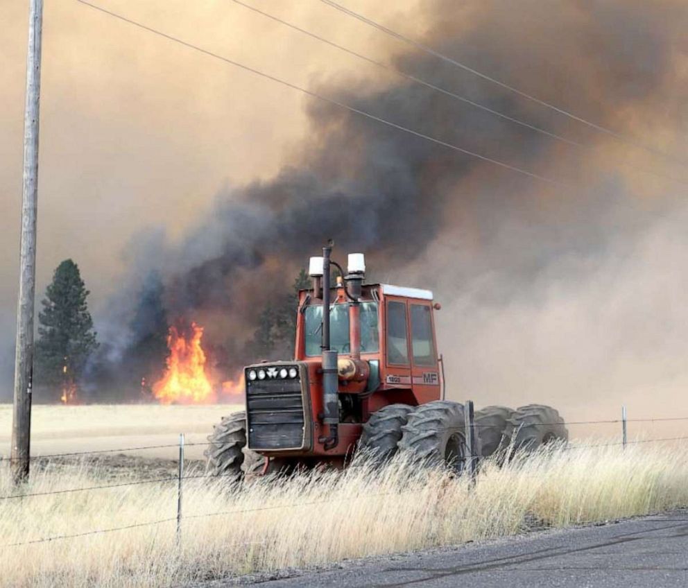 PHOTO: A farmer digs a fire line with his tractor in Medical Lake, Wash., on Aug. 19, 2023.