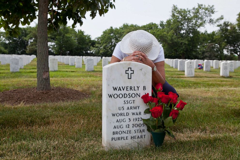 PHOTO: In this undated photo provided by Linda Hervieux,  Joann Woodson kneels at the gravesite of her husband Cpl. Waverly B. Woodson Jr. at Arlington National Cemetery in Arlington, Va. Members of Congress on Sept. 8, 2020.