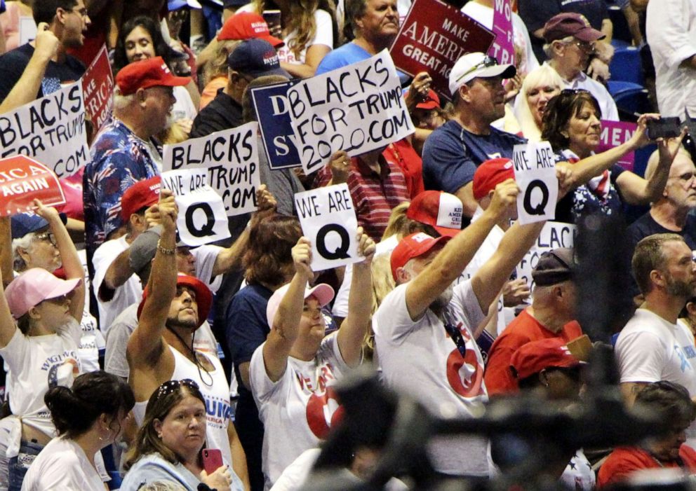 PHOTO: Supporters of President Donald Trump raise "We are Q" signs during a rally in Tampa, Florida, July 31, 2018.