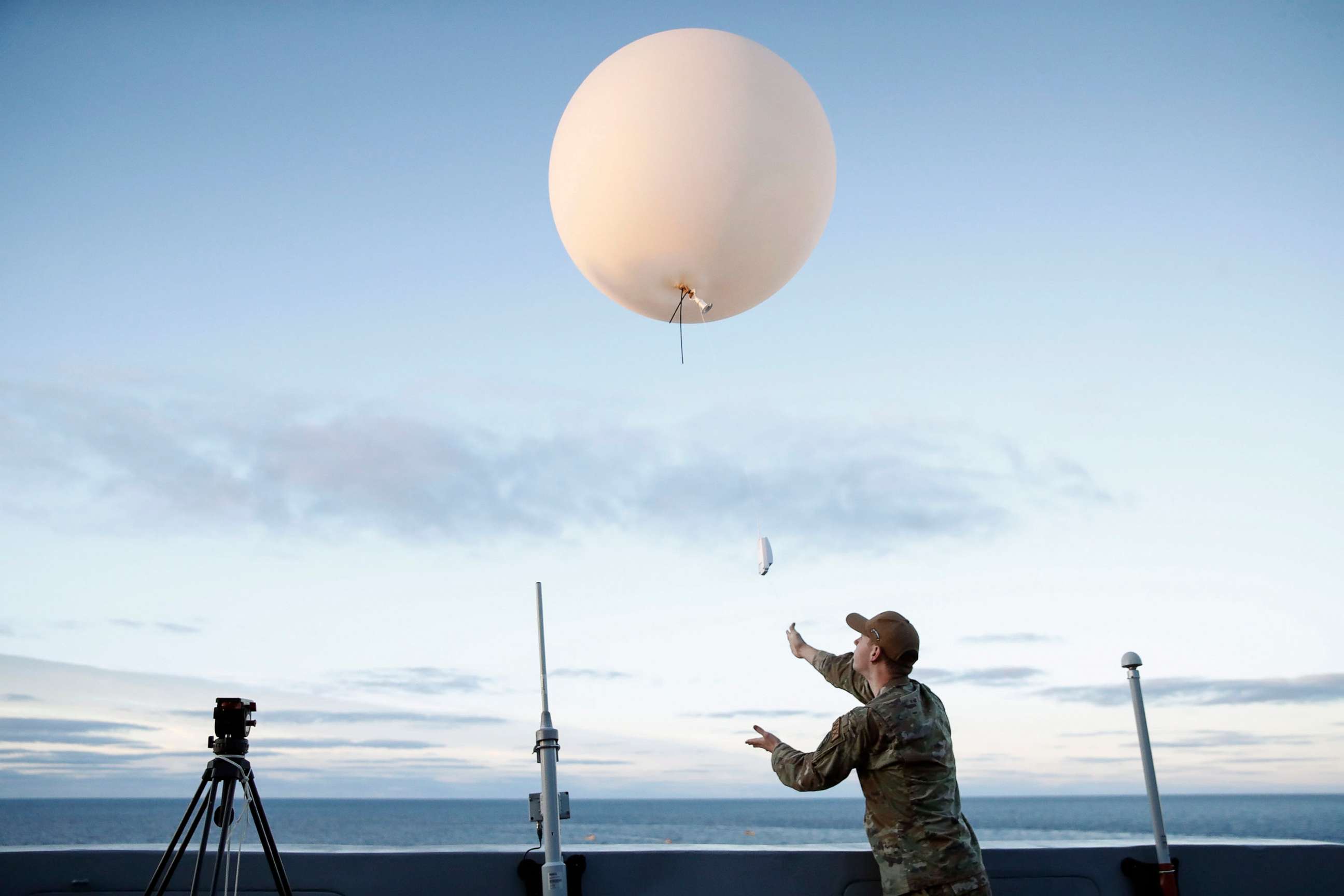 PHOTO: An Air Force member releases a weather balloon off the deck of the U.S.S. Portland, Dec. 11, 2022, in the Pacific Ocean off the coast of Baja California, Mexico.
