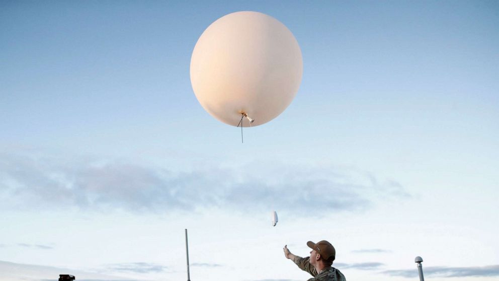 PHOTO: An Air Force member releases a weather balloon off the deck of the U.S.S. Portland, Dec. 11, 2022, in the Pacific Ocean off the coast of Baja California, Mexico.