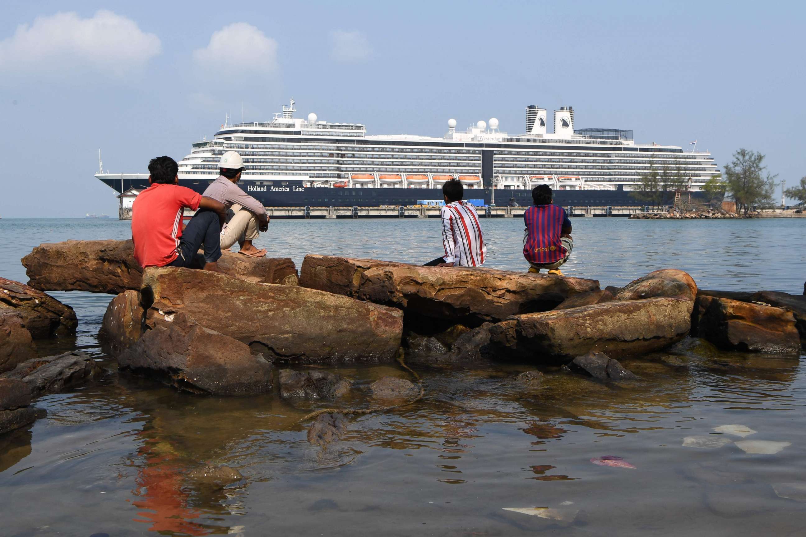 PHOTO: People on shore look at the Westerdam cruise ship docked in Sihanoukville on Feb.20, 2020. Dozens of passengers, stuck for nearly a week, on the ship have disembarked.