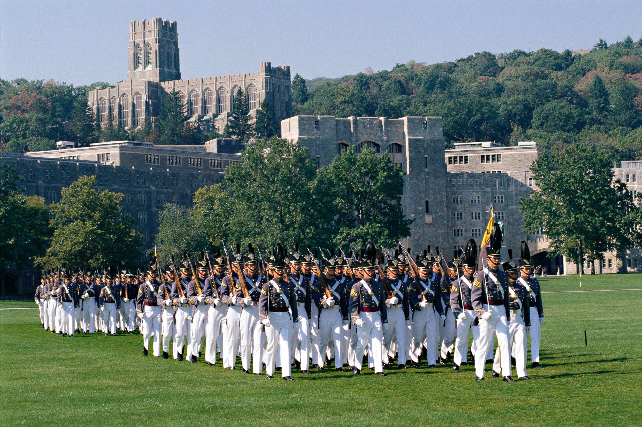 PHOTO: Members of the honor guard of the United States Military Academy at West Point march in formation along an athletic field.