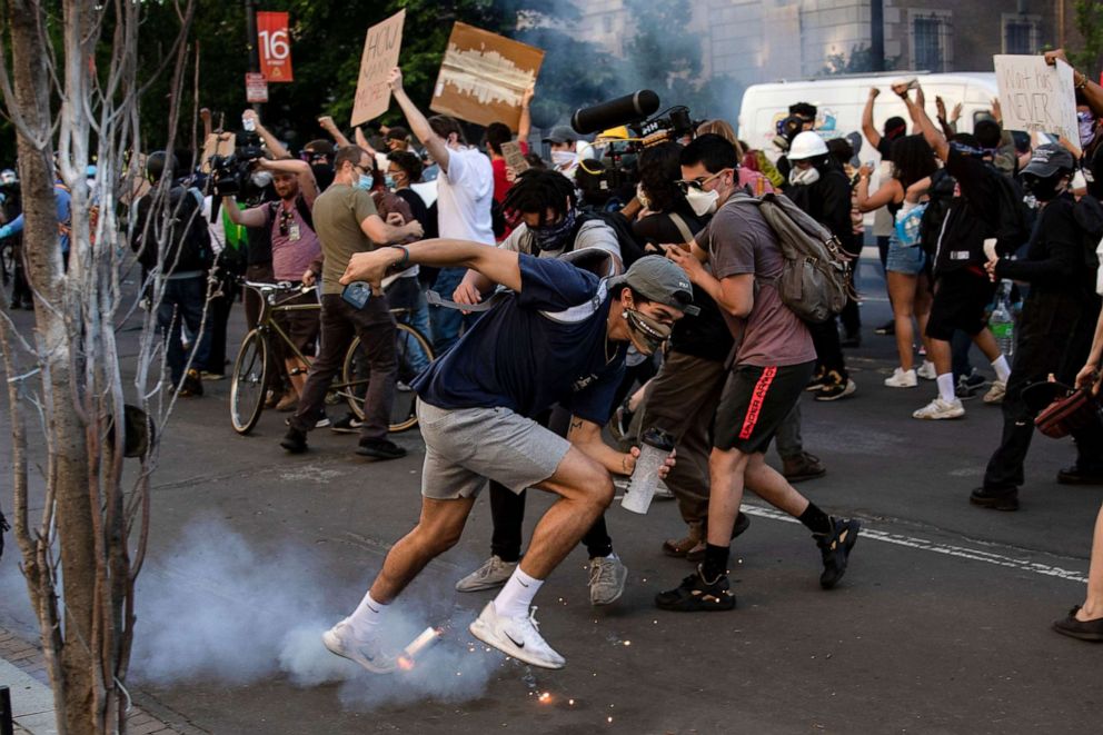 PHOTO: A gas canister lands at the feet of protestors during a demonstration over the death of George Floyd, near the White House, in Washington, D.C., June 1, 2020. 