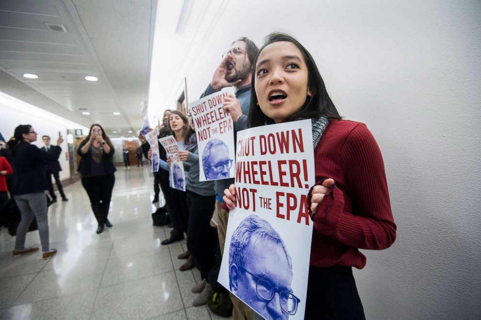 PHOTO: Protesters line the hallway outside of the confirmation hearing for Andrew Wheeler to be administrator of the Environmental Protection Agency in the Senate Environment and Public Works Committee, Jan. 16, 2019.